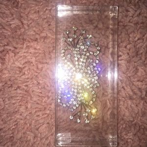 Clothing pin with jewels.